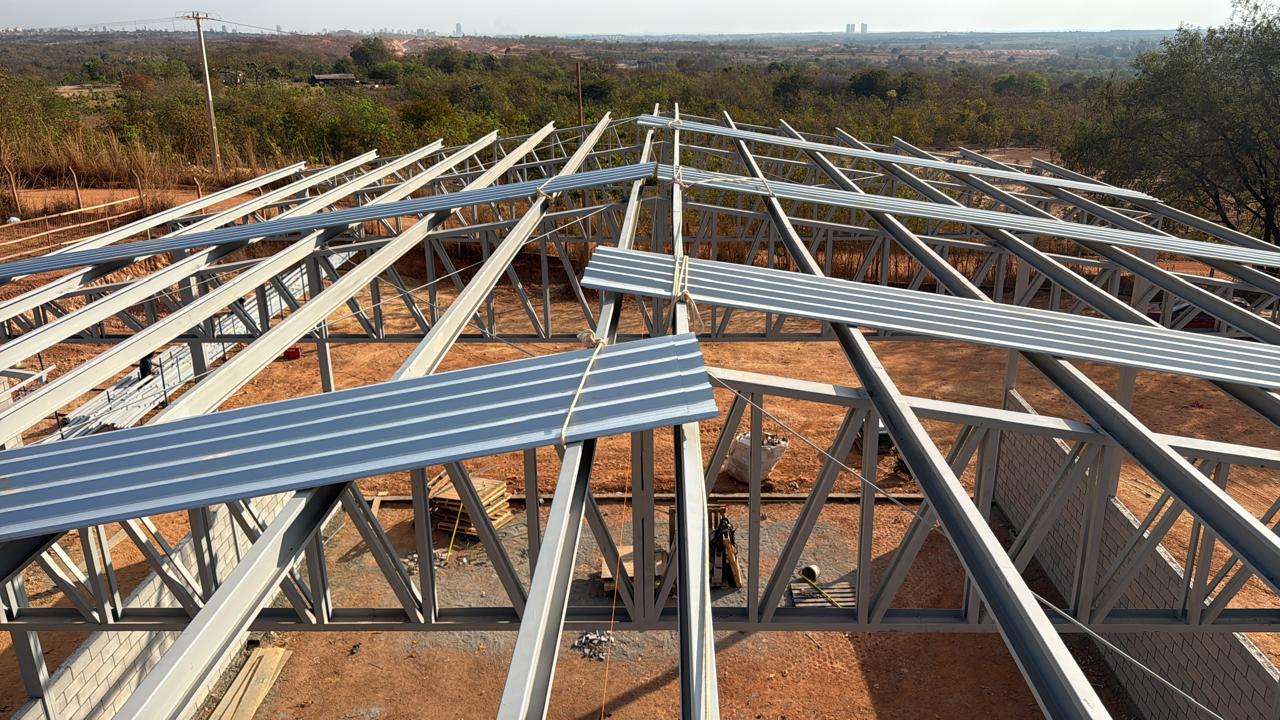Perfis e terças metálicas distribuídos sobre uma estrutura de cobertura